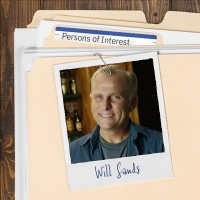 Photo of a smiling man with blond hair clipped to a manila folder