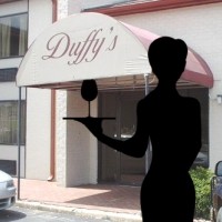 Silhouette of a waitress holding a tray in front of a photo of Duffy's bar