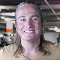 Smiling man with long graying hair pulled back