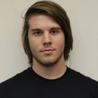 Young man with shaggy hair and scruffy facial hair