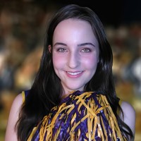 Smiling brunette young woman in a cheerleading outfit