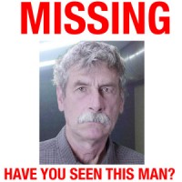Excerpt of a missing poster featuring a grumpy-looking man with bushy gray hair and mustache