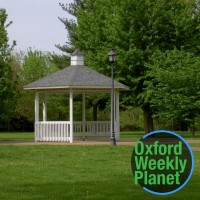 Gazebo in a park with the Oxford Weekly Planet logo in the foreground
