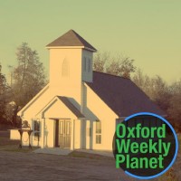 Photo of a white chapel with the Oxford Weekly Planet logo in the foreground