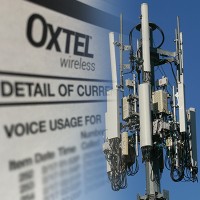 Close-up of a cell phone tower with an OxTel cell phone bill in the background