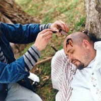 Stage blood being applied to create the head wound