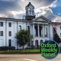 Oxford, MS courthouse with the Oxford Weekly Planet logo in the foreground