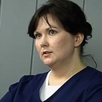 Brunette woman in hospital scrubs