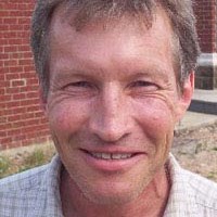 Smiling man with brown and gray hair