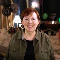 Smiling woman with short red hair