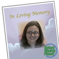 Funeral card with a photo of a smiling brunette woman with glasses with the Oxford Weekly Planet logo in the foreground