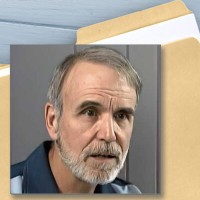 File folder with a photo of a man with salt-and-pepper hair and facial hair