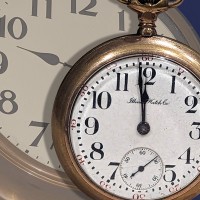 old-fashioned pocket watch with a clock in the background