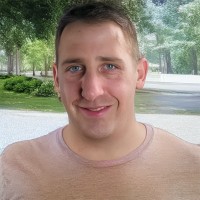Smiling man with close-cropped medium brown hair