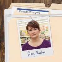 Photo of a weary woman with dark hair clipped to a manila folder