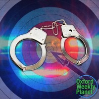 Handcuffs in front of an arrow and archery target with the Oxford Weekly Planet logo in the foreground