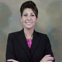 Smiling businesswoman with arms folded