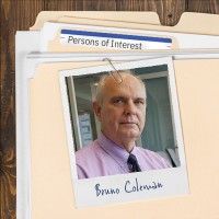 Photo of a balding man with gray hair, clipped to a manila folder