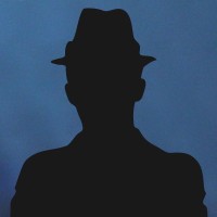 Silhouette of a man in a fedora