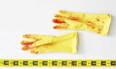 yellow work gloves with red stains