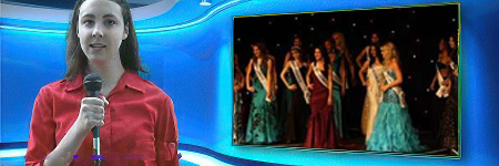 News reporter with microphone in front of a TV studio screen showing footage from a beauty pageant