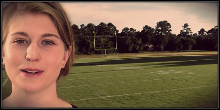 Blonde woman with a football field in the background