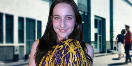 Smiling brunette young woman holding cheerleading pompoms