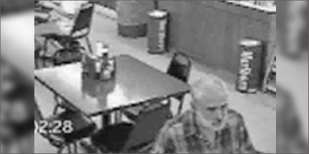 Black & white security video of a restaurant