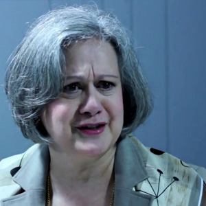 Middle-aged woman with a salt-and-pepper bob hairstyle