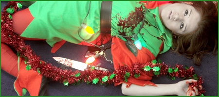 Young woman in a Christmas elf costume with a bloodstain on the left chest and a red-stained butcher knife on the floor beside her