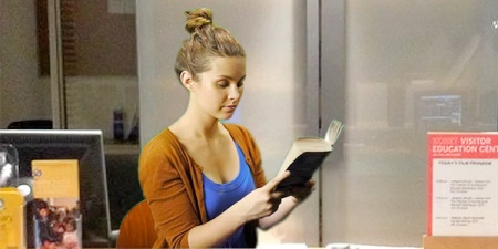 Smiling young woman holding a book