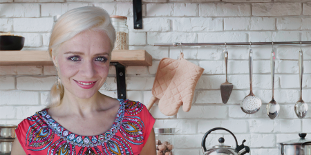 Blonde woman in an upscale household kitchen