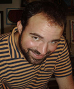 Balding man with dark hair and facial hair