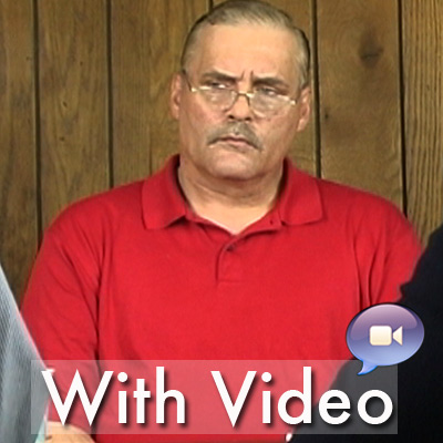 Older man with glasses, thinning gray hair and a mustache