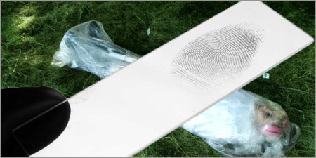 Gloved hand holding a collected fingerprint with Jasmine's tarp-wrapped body in the background