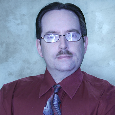 Man with glasses and a dark mustache