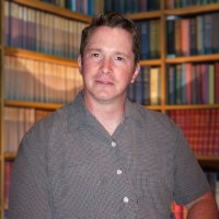 Serious man with short brown hair in a library