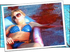Girl in bikini lying on a raft in a pool with blood evident in the water