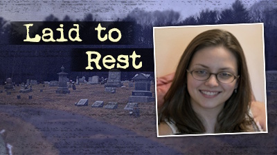 Smiling brunette woman with glasses with a cemetery in the background