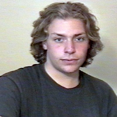 Young man with shaggy, dark blond hair