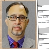 Serious-looking man with glasses with a criminal history form in the background