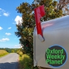 Residential mailbox with the flag up and the Oxford Weekly Planet logo in the foreground