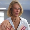 Older woman with blonde hair and glasses