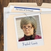 Photo of a serious woman with glasses and short salt-and-pepper hair, clipped to a manila folder