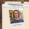 Photo of a young man with shaggy blond hair clipped to a manila folder