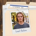 Photo of a young man with shaggy blond hair clipped to a manila folder