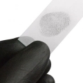 Gloved hand holding strip of paper with a fingerprint on it