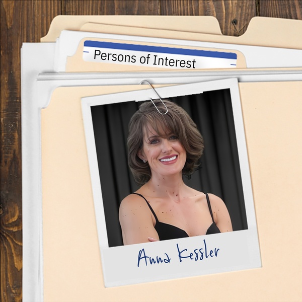 Manila folder with a photo of an attractive smiling woman with dark hair clipped to it
