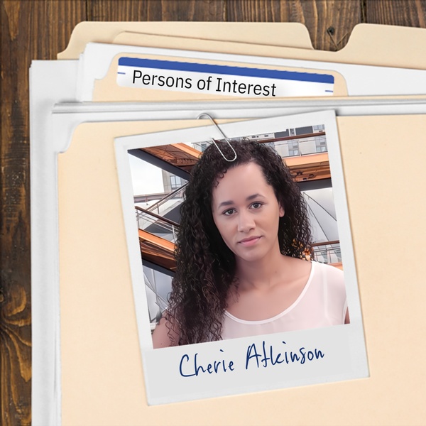 Manila folder with a photo of a striking young woman with long dark curly hair clipped to it