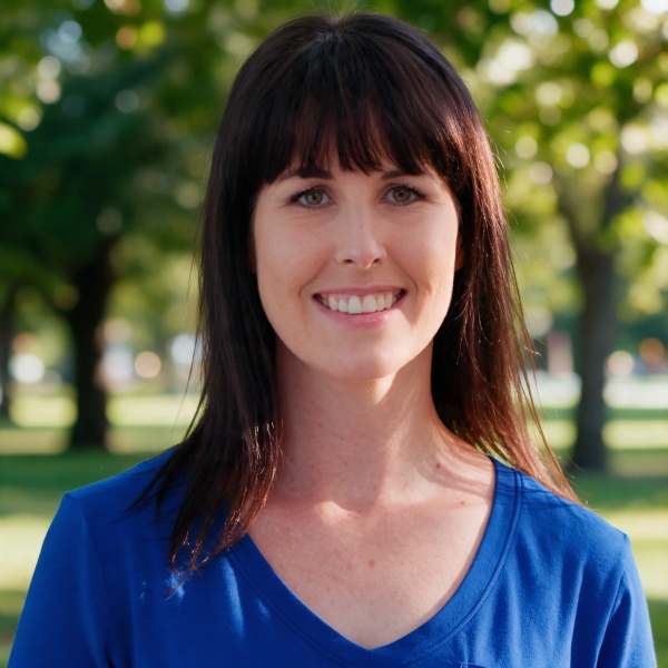 Smiling woman with shoulder-length dark hair and bangs